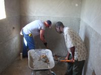 Joe and Salonique cleaning the bathroom area