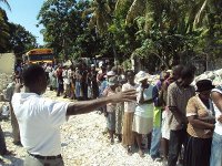 Praying with the victims of Leogane before starting the distribution