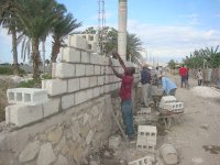 Workers are busy with the wall of the Church property