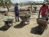 Salvaging concrete blocks from the school  campus wall