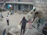 Principal shooting basketball on dirt court