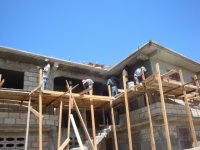 Putting stucco on the second floor of the second school