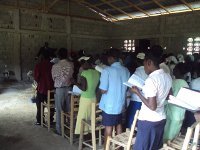 Ezechiel, the minister of the Marmelade Church leading singing