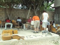 Missionaries putting the chairs back together