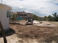 Bobcat is clearing and cleaning work site